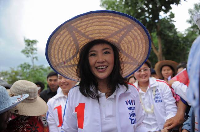 This file picture taken on June 12, 2011 shows then-candidate for the opposition Puea Thai party, Yingluck Shinawatra, the sister of former prime minister Thaksin Shinawatra, smiling as she walks through a crowd of supporters during an election rally in the northern Thai town of Chiang Kong. (AFP-Yonhap)