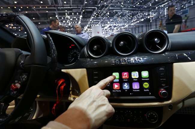 Apple’s CarPlay system on Ferrari FF’s touchscreen console, shown at the Geneva Motor Show in March (Bloomberg)