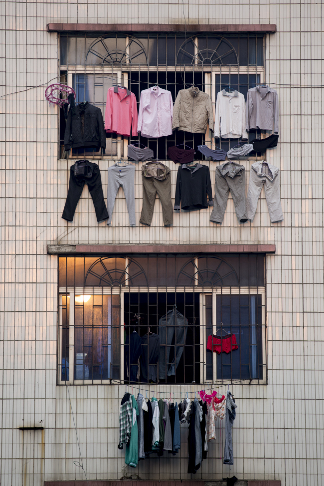 Laundry hangs to dry outside a residential building in the Zhujiang New Town district of Guangzhou, Guangdong province, China. (Bloomberg)