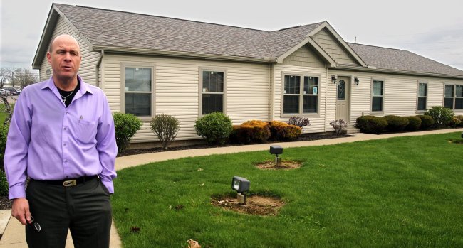 Dave Ball, sales manager with Hartzler’s Quality Housing, stands outside a Skyline modular home in New Philadelphia. (Akron Beacon Journal/MCT)