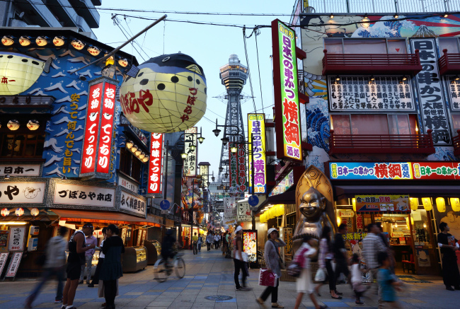 People walk past restaurants in the Shinsekai shopping district of Osaka. (Bloomberg)