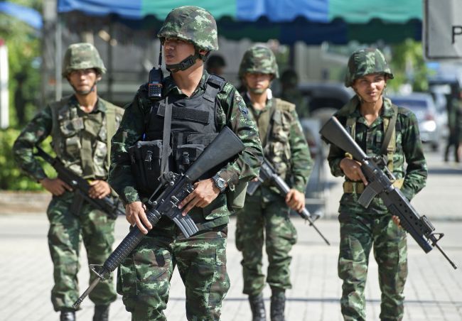 Thai soldiers patrol near where pro-government are rallying on the outskirts of Bangkok on Wednesday. (AFP)