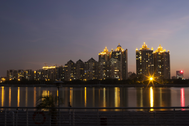 Residential apartment buildings are illuminated at night along the Zhujiang River in Guangzhou, Guangdong province, China. (Bloomberg)