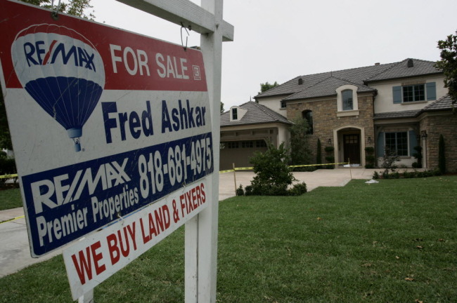 A “for sale” sign stands outside a home in Arcadia, California. (Bloomberg)