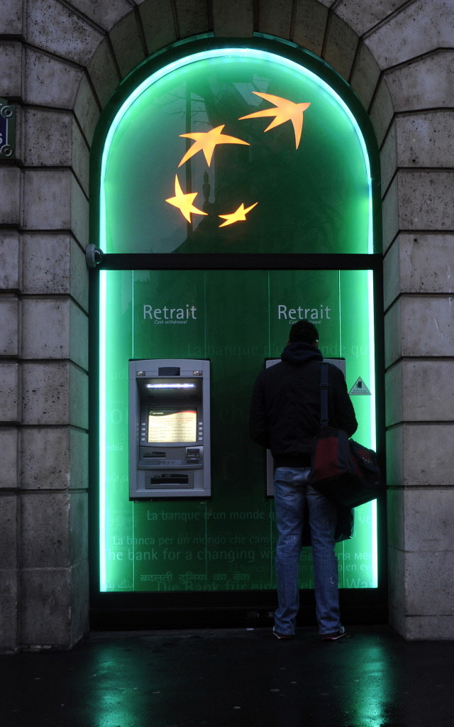 A customer uses an automated teller machine at a BNP Paribas bank branch in Paris. (Bloomberg)