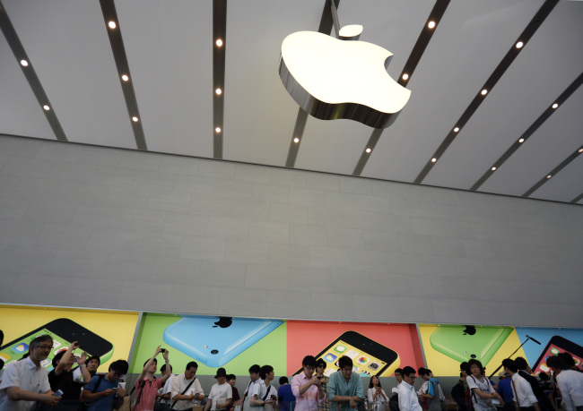 Customers browse inside the company’s Omotesando store in Tokyo. (Bloomberg)