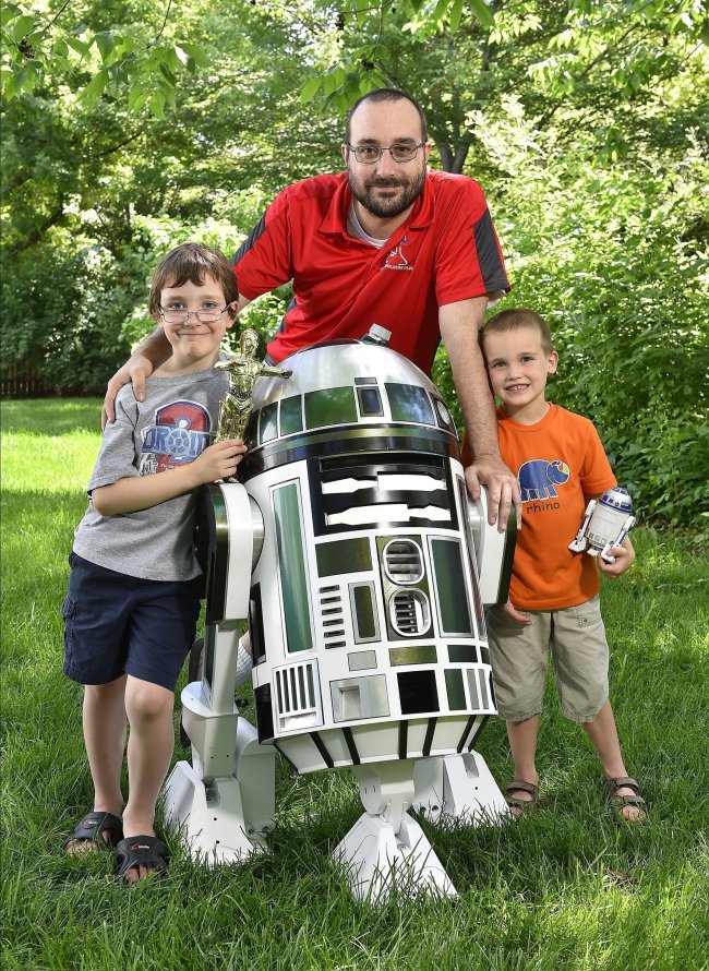 After watching Star Wars with his sons, Alex (left) and Zach, George Westwater of Lenexa, Kansas, decided to build an R2-type droid with them. (Kansas City Star/MCT)