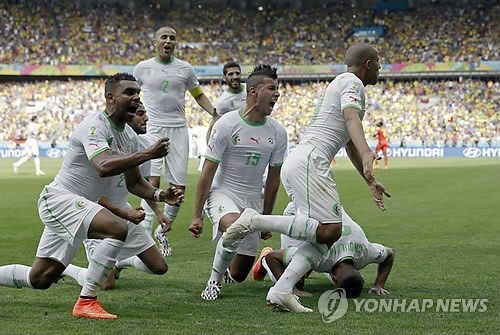 Algeria's Sofiane Feghouli, right, celebrates after scoring the opening goal during the group H World Cup soccer match between Belgium and Algeria at the Mineirao Stadium in Belo Horizonte, Brazil, Tuesday, June 17, 2014. (AP Photo/Hassan Ammar)
