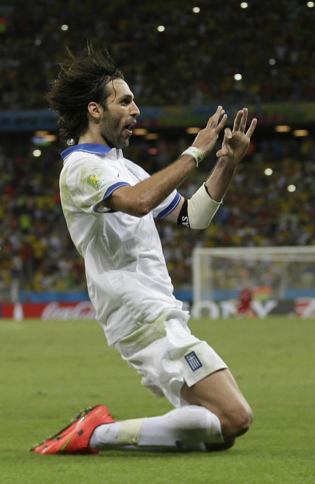Greece`s Giorgos Samaras celebrates scoring his side`s second goal during the group C World Cup soccer match between Greece and Ivory Coast at the Arena Castelao in Fortaleza, Brazil, Tuesday. (AP)
