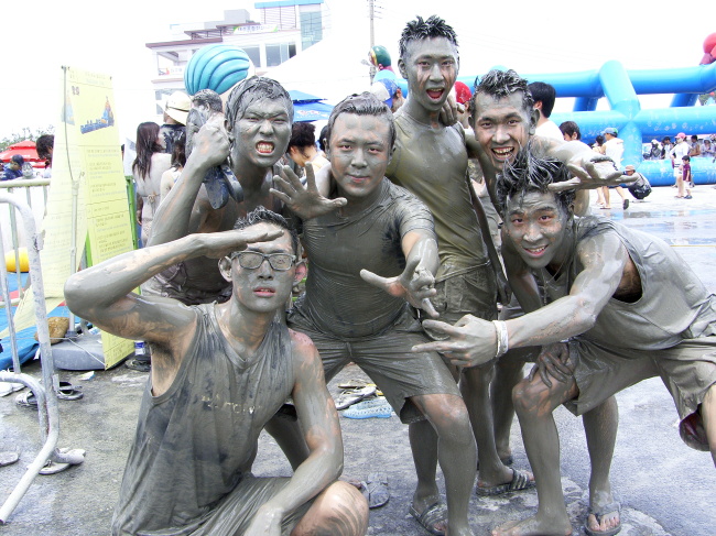 Revelers pose for photographers at the 2013 Boryeong Mud Festival. (Boryeong Mud Festival)