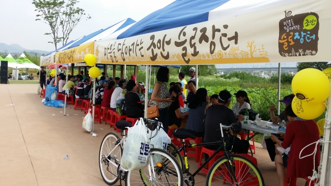 Visitors look around the Joan Slow Market, a oneday outdoor market that sells local farm produce, held in Namyangju, Gyeonggi Province, on June 14. (The Joan Slow Market)
