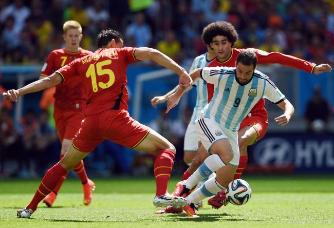 Belgium`s defender Daniel Van Buyten (L) vies with Argentina`s forward Gonzalo Higuain during a quarter-final football match between Argentina and Belgium at the Mane Garrincha National Stadium in Brasilia during the 2014 FIFA World Cup on Saturday. (AFP)