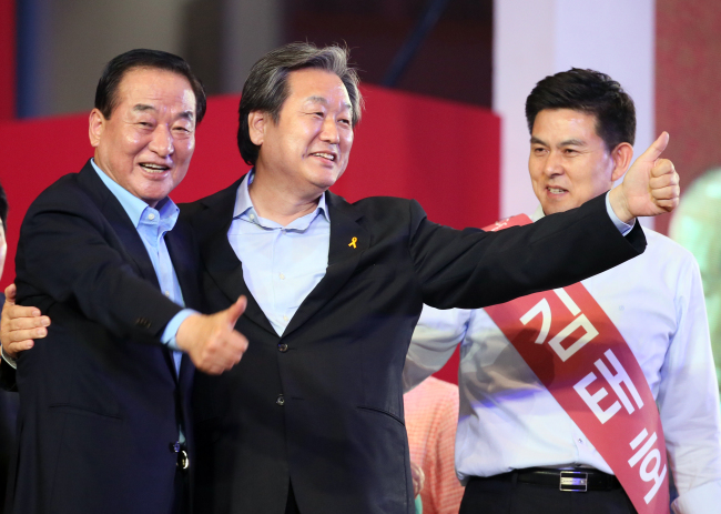 Newly elected Saenuri Party chairman Rep. Kim Moo-sung (center) poses with new supreme council members Reps. Suh Chung-won (left) and Kim Tae-ho at the party convention at Seoul Sports Complex in eastern Seoul on Monday. (Yonhap)
