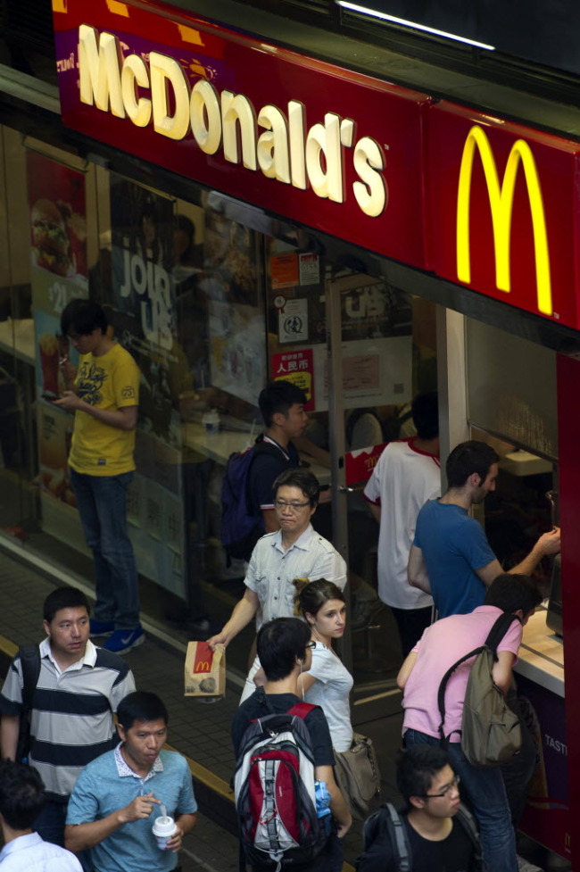 Pedestrians walk past a McDonald’s in Hong Kong. (Bloomberg)