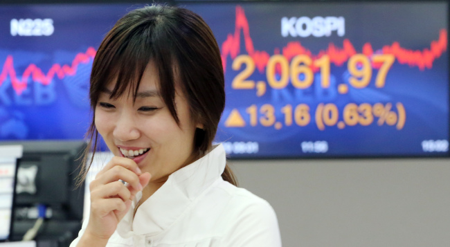 Trading numbers are displayed at the Korea Exchange Bank headquarters in Seoul on Tuesday. Stocks hit a new high, rising 13.16 points, or 0.64 percent, to 2,061.97. (Yonhap)