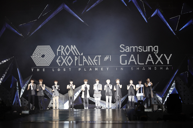Members of K-pop group EXO speak to the press during their world tour stop in Shanghai on July 18. (Yonhap)