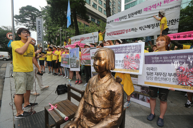 University students protest Japan’s defense policies outside the Japanese Embassy in Seoul on Tuesday. (Yonhap)