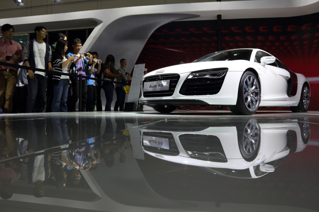 Visitors look at an Audi R8 vehicle at the Wuhan Motor Show in Wuhan, China. (Bloomberg)