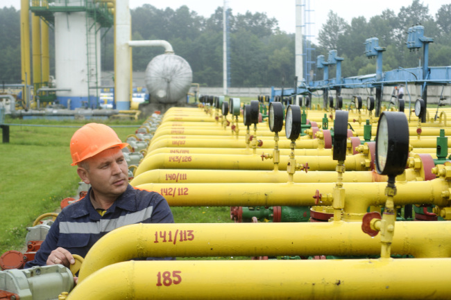 An employee adjusts a control wheel on pipework at the Dashava underground gas storage facility in Lviv, Ukraine. ( Bloomberg)