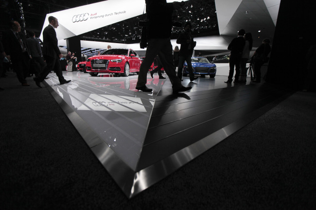 Attendees walk past the Audi stand during the 2014 North American International Auto Show in Detroit, Michigan. (Bloomberg)