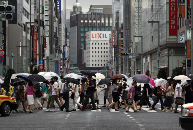 Pedestrians and shoppers cross a road in the Ginza district of Tokyo. (Bloomberg)