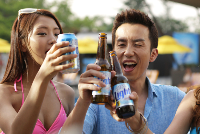 Singer Yoo Hee-yeol (right), advertising model for OB’s low-calorie beer Cass Light. (OB)