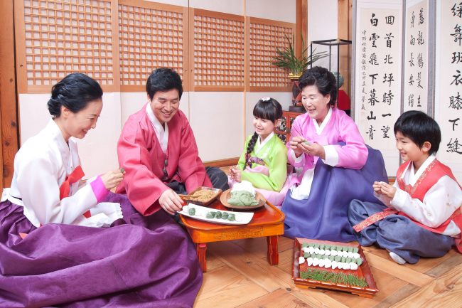 Family members gather to make songpyeon, a traditional Korean rice cake enjoyed during Chuseok. (Korea Tourism Organization)