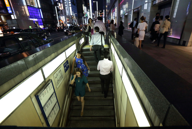 Pedestrians descend a flight of stairs in the Ginza district of Tokyo. (Bloomberg)