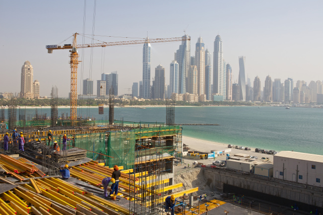 Construction workers build a waterfront apartment block on Palm Jumeirah island in Dubai. (Bloomberg)