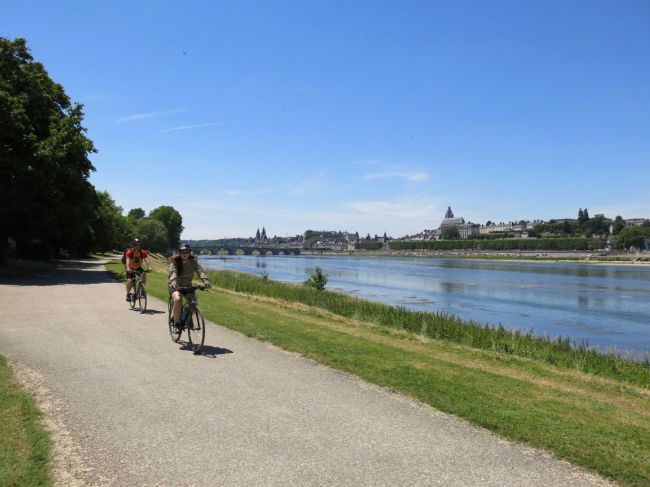 Cyclists bike along the Loire River near Blois, France. (AP)