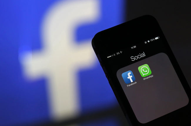 The Facebook and WhatsApp applications’ icons are displayed on an iPhone in London. (Bloomberg)