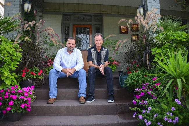 Kevin Prall (left) and Layne Bennett pose for a portrait on Aug. 30 on the porch of the house they purchased in New Kensington, Pennsylvania, in 2011. (Pittsburgh Post-Gazette/MCT)