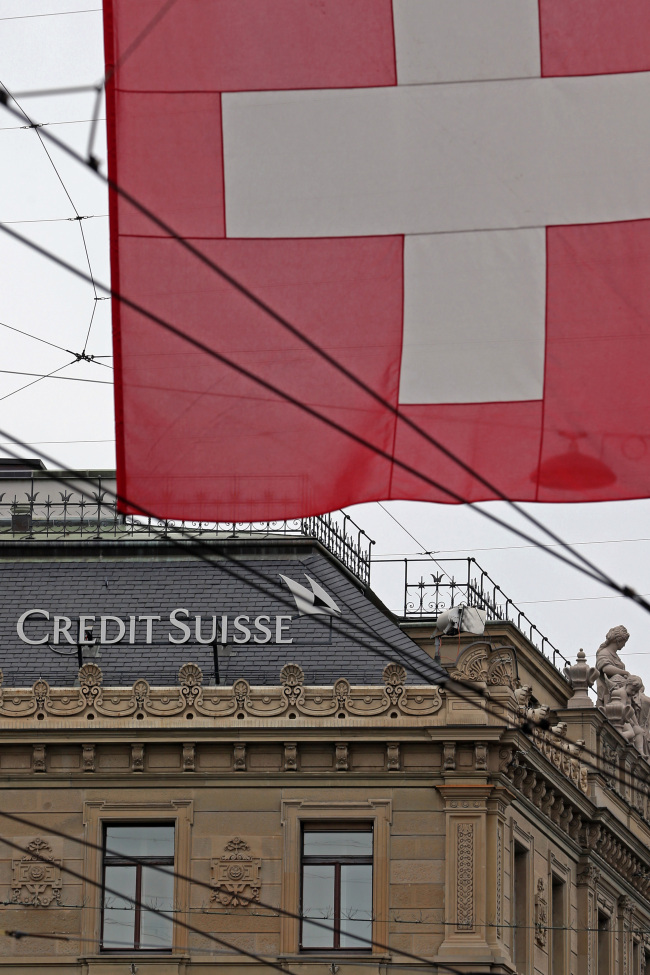 A Swiss national flag flies near the headquarters of Credit Suisse in Zurich, Switzerland. ( Bloomberg)