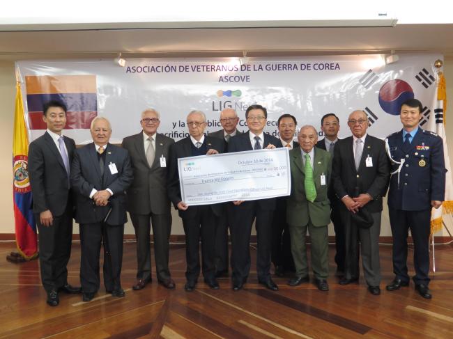 LIG Nex1 COO Lee Joung-sik (sixth from left) gives a donation to Colombia’s Korean War veterans in Bogota last week. (LIG Nex1)