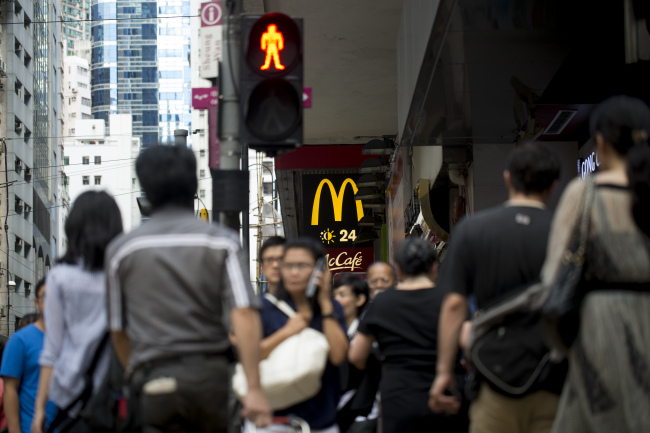 Pedestrians walk past a McDonald’s in Hong Kong. (Bloomberg)