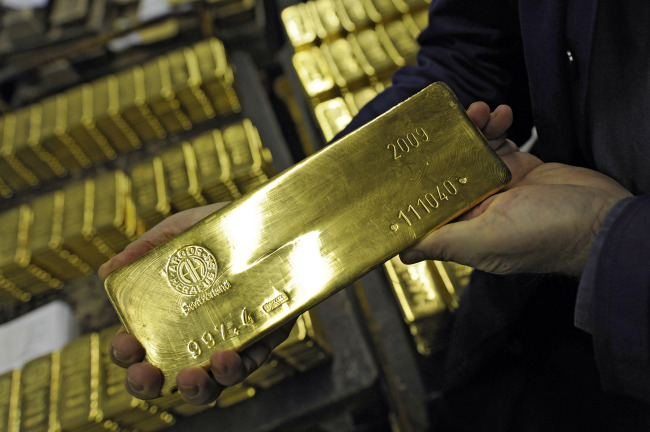 An employee shows a gold bar at the Argor-Heraeus gold producing and refining plant in Mendrisio, Switzerland. (Bloomberg)