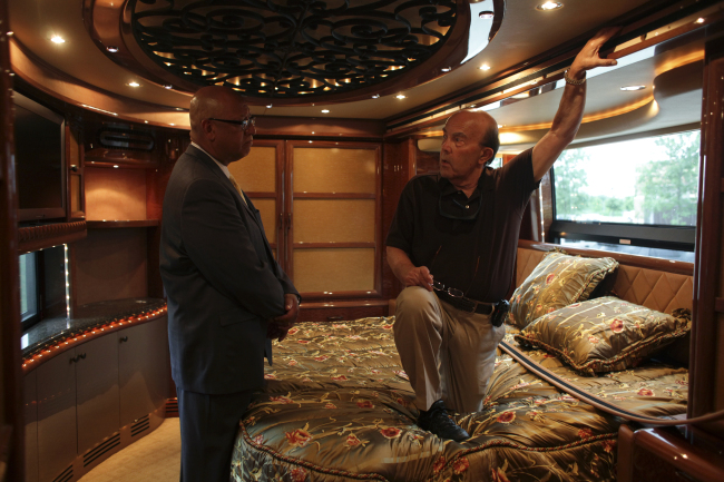 A prospective buyer talks with U.S. Marshall Kevin Carr (left), inside Rita Crundwell’s motor home at the Oak Creek Police Department in Oak Creek, Wisconsin, July 26, 2012. (Chicago Tribune/TNS)