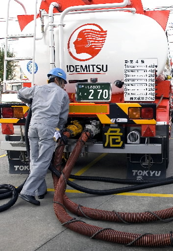 A tank truck driver pumps out gasoline into reserve tanks at an Idemitsu Kosan gas station in Tokyo. (Bloomberg)