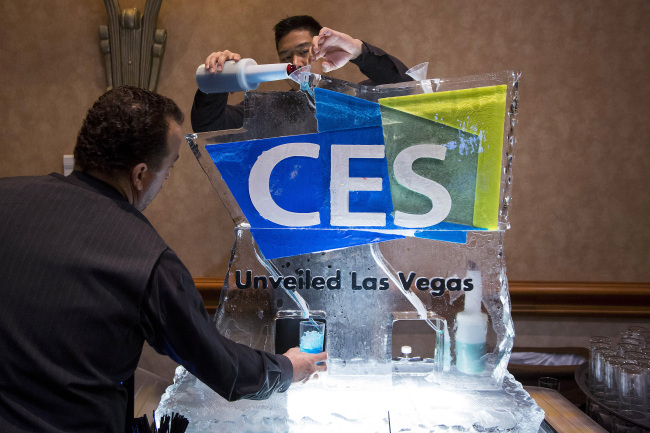 Workers pour a blue vodka-based drink through a CES-branded ice luge during the CES Unveiled press event ahead of the 2015 Consumer Electronics Show in Las Vegas, Nevada, U.S., on Sunday. (Bloomberg)