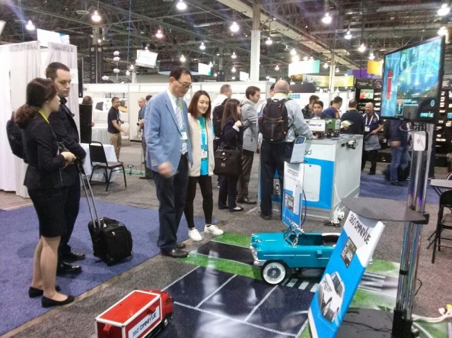 Baek Won-in (third from left), the chief executive of ImageNEXT, inspects his company’s booth at 2015 International CES in Las Vegas on Tuesday. (Kim Young-won/The Korea Herald)