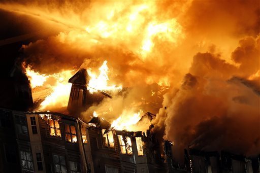 An apartment complex is engulfed by flames, Wednesday, Jan. 21, 2015, in Edgewater, N.J. Authorities had not determined the cause of the fire. (JULIO CORTEZ — AP Photo)