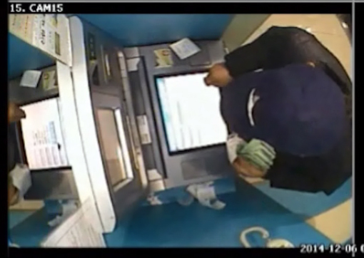 A voice phishing scammer is caught on CCTV camera installed at a bank in Seoul. (Yonhap)