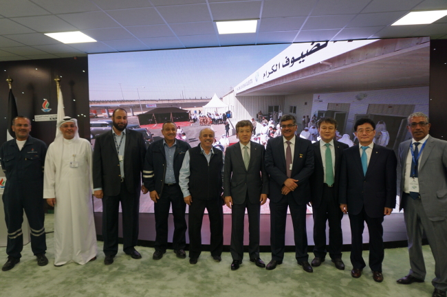 Daewoo E&C CEO Park Young-sik (fifth from right) poses with top Kuwaiti officials at a ceremony to commemorate the launch of a clean fuels project in Kuwait on Tuesday. (Daewoo E&C)