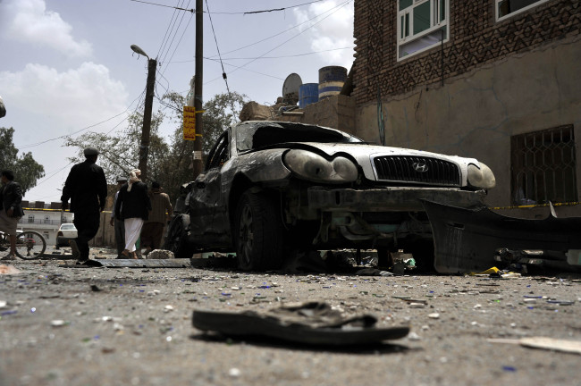 A damaged car and a shoe of a victim are seen in Sanaa, Yemen, Saturday. (Xinhua-Yonhap)