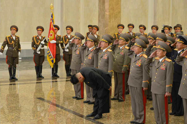North Korean leader Kim Jong-un (front) pays his respects to his late grandfather, national founder Kim Il-sung, at the Kumsusan Palace of the Sun in Pyongyang on Wednesday. (Yonhap)