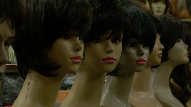A scene from the wig making video, part of Lee Wan’s “Made in Korea” series