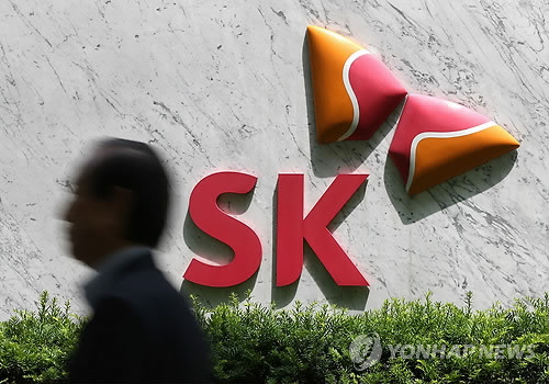 A man walks past the headquarters of SK Group in central Seoul. (Yonhap)