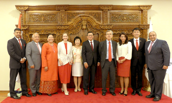 Indian Ambassador Vikram Doraiswami, Turkish Ambassador Arslan Hakan Okcal, Malaysian Ambassador Rohana Ramli, Austrian Ambassador Elisabeth Bertagnoli, CICI president Choi Jung-hwa, Indonesian Ambassador John Prasetio, Spanish Ambassador Gonzalo Ortiz, congresswoman Jasmine Lee, Singaporean Ambassador Wei Kiat Yip and Kuwaiti Ambassador Jasem Albudaiwi pose at a reception at the Indonesian Embassy on Tuesday organized by the Korea CQ Club. (Joel Lee/The Korea Herald)