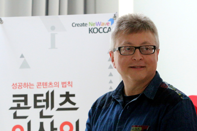 Michael E. Uslan, one of the main producers of the “Batman”/“Dark Knight” Hollywood film series, speaks during a group interview with members of the media on Tuesday at Hongik Daehangno Art Center in Seoul. (KOCCA)