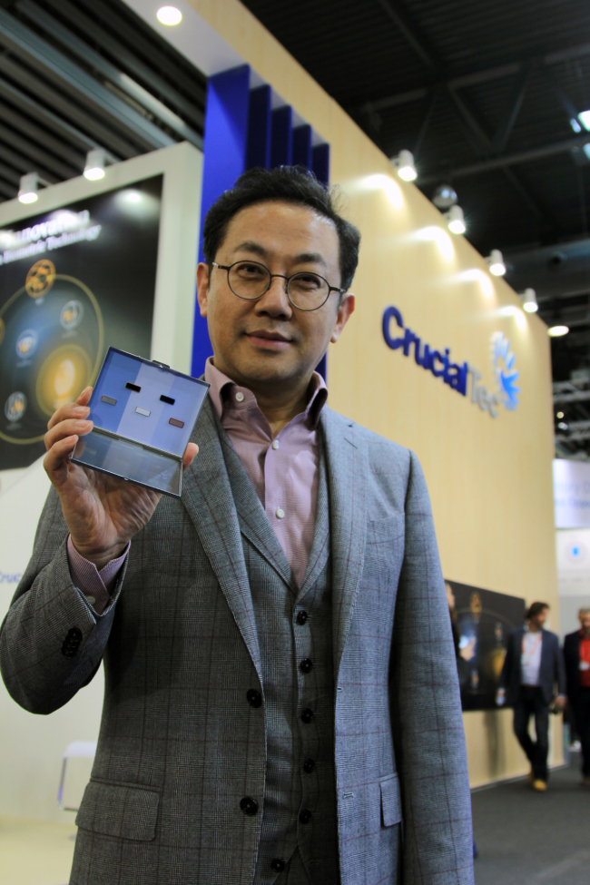 CrucialTec CEO Charles Ahn poses with fingerprint modules at the MWC on Monday. (CrucialTec)
